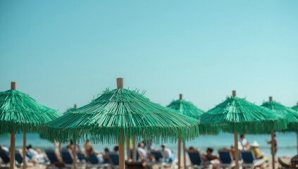 Green straw beach umbrellas in focus with a blurred background of beach chairs and visitors, illustrating outdoor relaxation