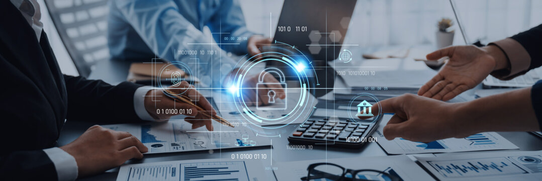 A dynamic business team collaborates in a modern office setting focused on security data and financial analysis, utilizing advanced technology and engaging discussions. Trope - Powered by Adobe