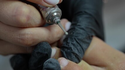 Professional manicure close-up with nail technician cleaning cuticle area using electric drill, detailed nail preparation process, black gloves, beauty salon hygiene concept, ultra macro aesthetic sho