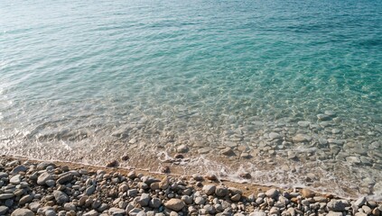 Sunlit scene of crystal-clear sea water and stones, suitable for text overlay backgrounds