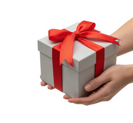 Pair of hands holding beautifully wrapped light gray square gift box decorated with bright red satin ribbon and bow ready for presentation