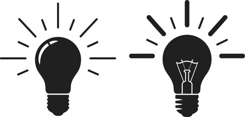 Two black light bulb icons with rays ideal for design on transparent background silhouette © mst