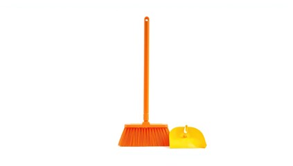 Plastic broom with orange bristles on a plain white backdrop, suitable for everyday cleaning and maintenance