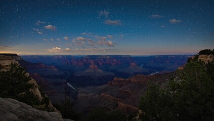 Obraz premium Nighttime scene of the Grand Canyon from Desert View Point with the Colorado River visible, emphasizing natural erosion