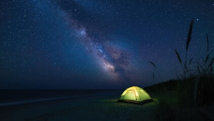 Overnight beach camping beneath the star-filled sky and the Milky Way galaxy, focused on outdoor recreation