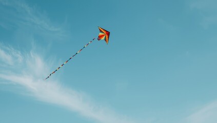 Brightly colored kite in motion under clear blue skies, suitable for outdoor leisure imagery, Earth Day