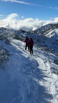 People hiking to Debela pec in winter