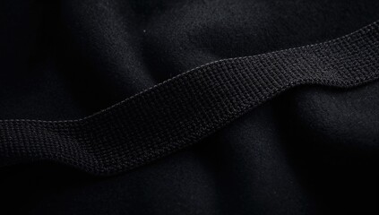 Black fabric surface with Velcro texture for patch fixing, used as a functional background in textile applications