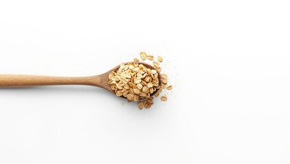 Oat flakes in wooden spoon on white background, highlighting health-conscious dietary choices