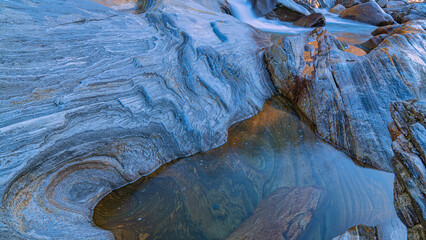 Blue water and rocks surface in the stunning landscape of the Verzasca Valley, Ticino, Switzerland