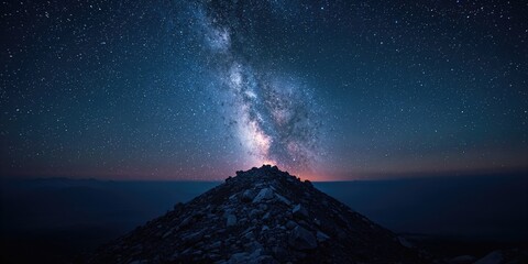 High-altitude mountain scene at night with star trails, suitable for astrophotography backgrounds