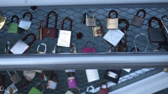 Closeup of love locks on a bridge people attach padlocks with names symbol of eternal love romantic gesture tourist attraction