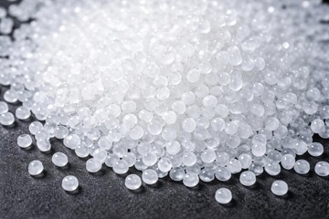 Close up capture of white plastic resin beads on dark surface for modern molding techniques