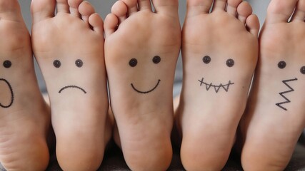 Five feet with different facial expressions drawn on them