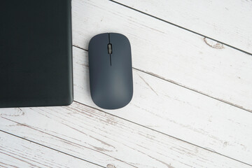 Minimal business workspace with laptop and mouse on white wooden desk representing productivity, digital work environment, and professional office setup with clean copy space.