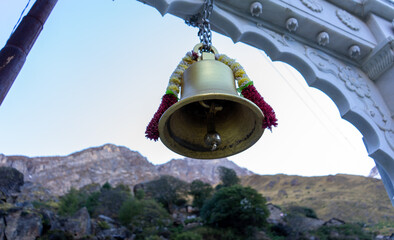 Brass Temple Bell Hanging from White Marble Arch in Himalayan Village