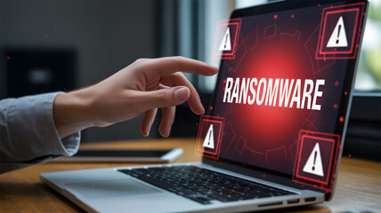 Cybersecurity Ransomware Attack Alert: Laptop Screen Displaying Red Warning Symbols and Data Threat