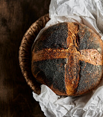 Loaf of homemade sourdough bread with poppy seeds. Copy space