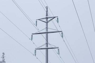 Ice and snow on the electricity wires during heavy snowfall in winter.