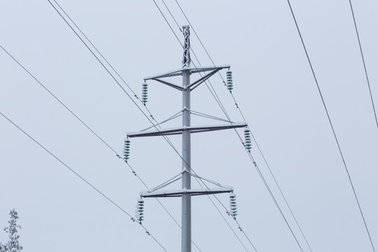 Ice and snow on the electricity wires during heavy snowfall in winter.