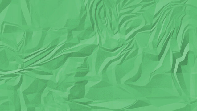 A close up view of a mint green textured surface with irregular patterns and wrinkled and crumpled paper texture.