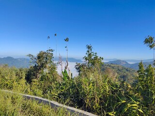 Scenic Mountain Landscape with Lush Green Trees and Blue Sky