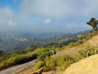 Panoramic View of Winding Hillside Road with Beautiful Mountain Scenery