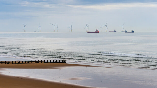 Offshore wind farm with cargo ships near Aberdeen beach
