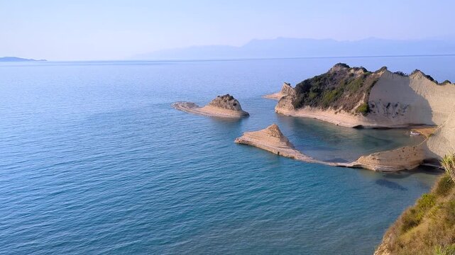 View of beautiful islands of unique shape on Cape Drastis. One of main attractions of Corfu (Kerkyra) island. Greece. Turquoise Ionian Sea around limestone rocks. Magnificent coastal landscape.