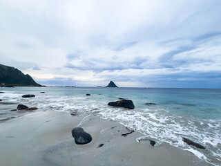 Serenity captured: a stunning beach with white sands and rocks meeting the turquoise waters of...