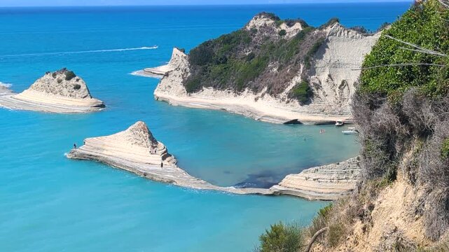 View of beautiful islands of unique shape on Cape Drastis. One of main attractions of Corfu (Kerkyra) island. Greece. Turquoise Ionian Sea around limestone rocks. Magnificent coastal landscape.