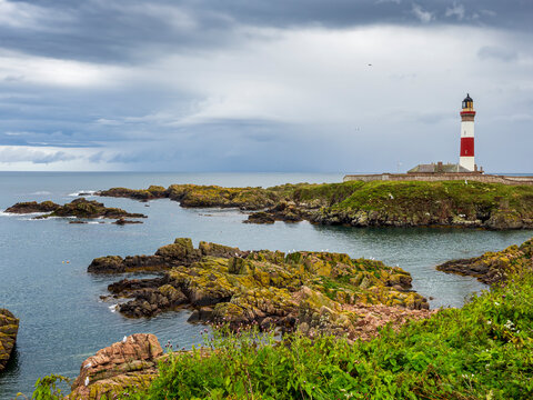 Buchan Ness lighthouse standing on Peterhead coastline