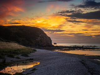 Sunset over a rocky beach and cliffs in Fraserburgh, Scotland