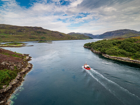 Fishing boat navigating Kyle of Durness in Scottish Highlands