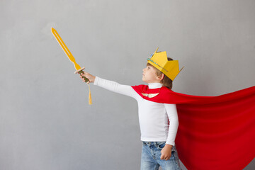 Child pretend to be knight. Kid having fun at home