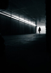silhouette of a man in a tunnel