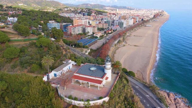Aerial drone flying over lighthouse and city of calella de mar