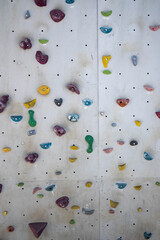 Colorful grips on a climbing wall. Sports and recreation.
