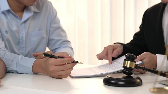 Couples file for divorcing and seek assistance from law firm to divide property after breakup. Obligations contract assist by lawyer in negotiating settlement agreement meeting. Slow motion. Rigid.