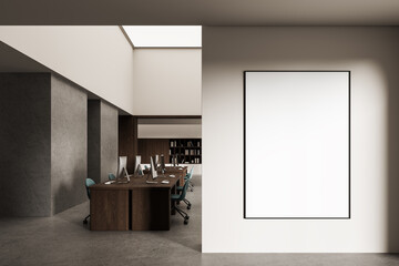 Blank poster mockup on bright wall in modern office interior with wooden desks and computers, clean design layout with natural lighting concept. 3D Rendering