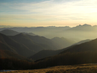 Beautiful panoramic view of hazy mountains in Tuscany at sunset, Italy. Soft golden light, atmospheric mist, and layered hills create a dreamy and tranquil landscape, capturing the timeless beauty of