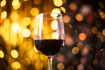 A glass of red wine with bokeh background for Christmas