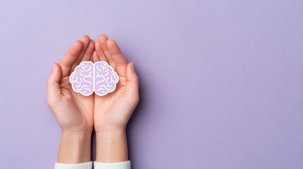 Brain care concept with hands gently holding paper cut brain icon on purple background, symbolizing mental health and protection with minimal style close up editorial photo