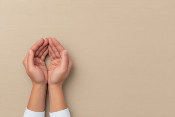 Hands holding gesture with cupped palms on beige background, symbolizing care, protection, or offering in minimal style close up editorial photo
