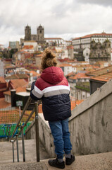 Fototapeta premium Little Boy Looking at Porto Cityscape View from a High Terrace.