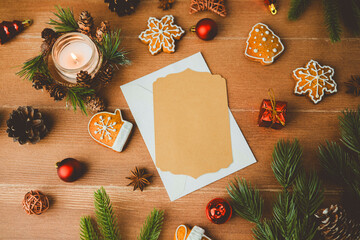 Cozy Christmas scene with candle cookies pinecones and blank card for festive greetings © reddish