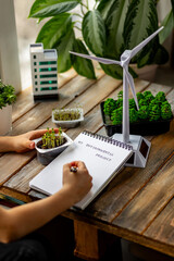 Ecology project, sustainable development education at school. Kid doing scientific research on renewable energy, biodiversity, recycling. Problems of global warming, climat change. Future city design