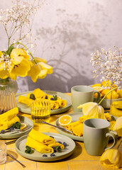 Celebrating spring breakfast with yellow pancakes and tulips