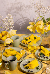 Yellow crepes with blueberries and lemons for brunch