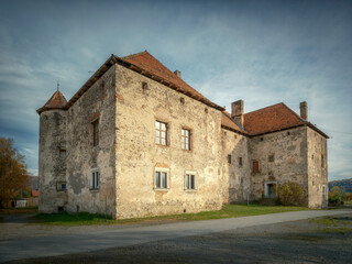 view to facade of old palace with red roof in cloudy day with soft sun light on the walls with copy space